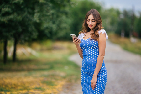 Portrait of woman with smart phone. Cropped image of young prettの写真素材