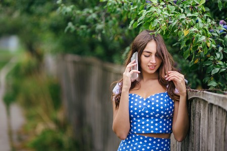 Fashion woman portrait of young pretty trendy smiling girl speakの写真素材