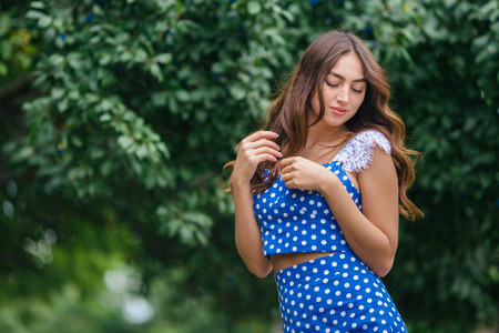 Fashion portrait of young pretty trendy girl with beautiful curlの写真素材