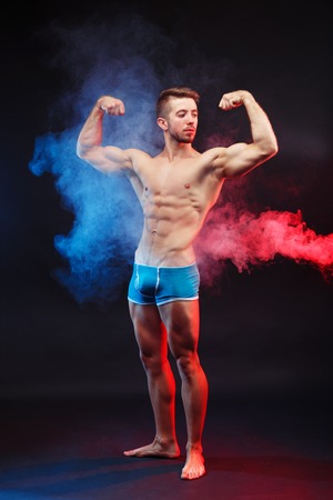 Young handsome muscular man bodybuilder with perfect abs, shouldの写真素材