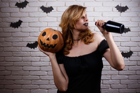 Halloween party, celebration concept. Woman with pumpkin partyinの写真素材