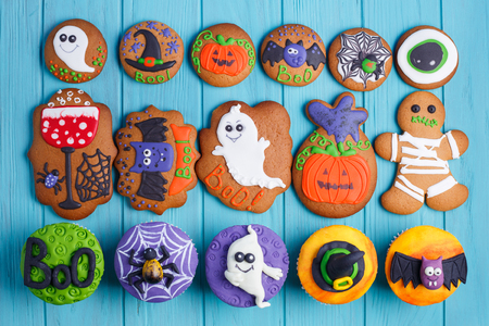 Halloween homemade gingerbread cookies and cupcakes background.の写真素材