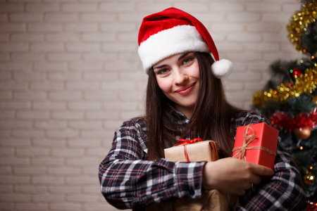 Portrait of young beautiful happy woman in Santa cap with severa