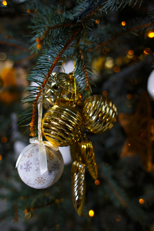 Golden and white Christmas decorations on the branches of fir trの写真素材