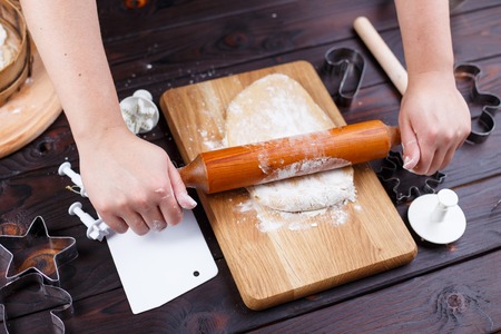 Gingerbread making. Woman rolling the dough with rolling pin onの写真素材