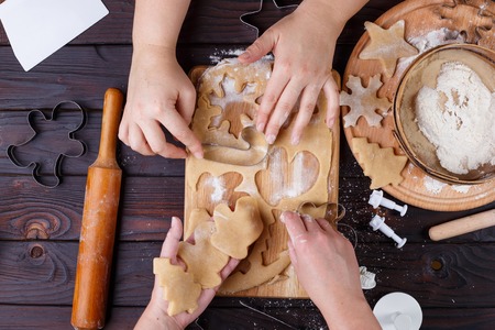 Christmas bakery. Friends cutting cookies of gingerbread dough,の写真素材