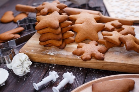 Freshly baked ready to decorating gingerbread cookies with cutteの写真素材