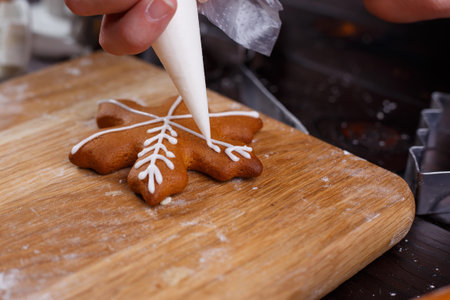 Decorating gingerbread cookie with confectionery icing. Traditio