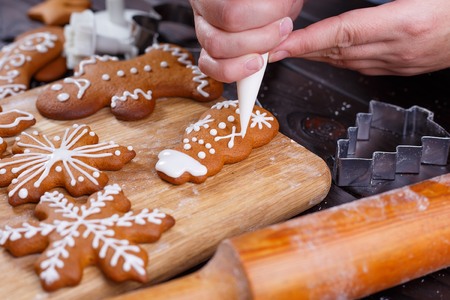 Christmas bakery. Process of decorating homemade gingerbread snoの写真素材