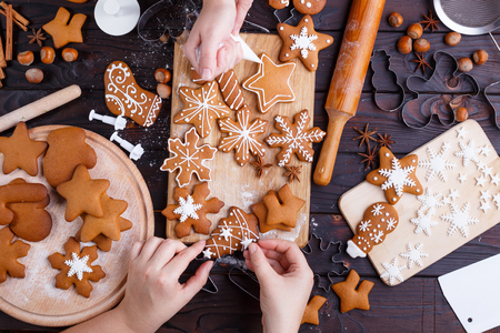 Cooking Christmas gingerbread. Friends decorating freshly bakedの写真素材