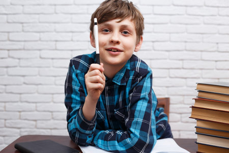 Cheerful and enthusiastic schoolboy answering the teachers ques