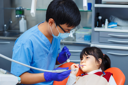 Dentist at work. Doctor and his young patient who is not afraidの写真素材