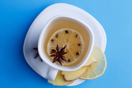 Cup of spicy warming ginger tea with lemon, flat lay. Tasty natuの写真素材