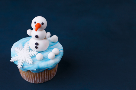 Funny homemade New Year party cupcake with snowman decoration maの写真素材