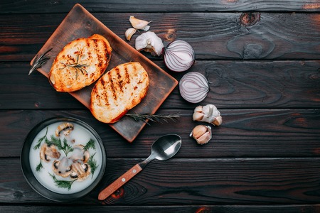 Delicious cream soup with champignons and crunchy grilled wheatの写真素材