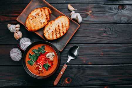 Tomato cream soup decorated with sliced champignons and tomatoesの写真素材