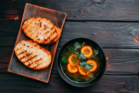Vegetable soup decorated with sliced carrots and green parsley aの写真素材