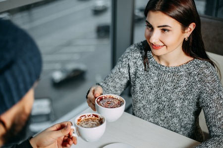 Loving young couple celebrating Valentines day drinking coffee hの写真素材
