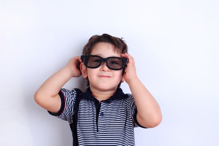 Happy lovely smiling boy in sunglasses, studio shoot on white. Cの写真素材