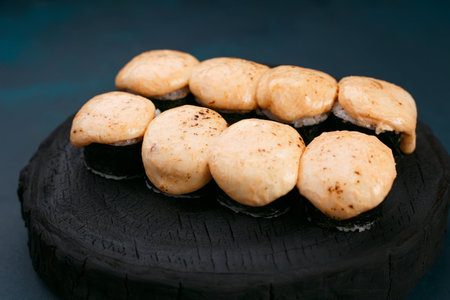 Delicious sushi rolls with melted cheese, close up. Japanese cuiの写真素材