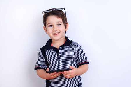 Cute happy boy playing on smartphone. Technology, children, lifeの写真素材