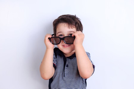 Cute funny little boy with sunglasses, studio shoot on white. Chの写真素材