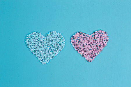 Pink and blue hearts of beads, copy space. Love, couple, boy andの写真素材