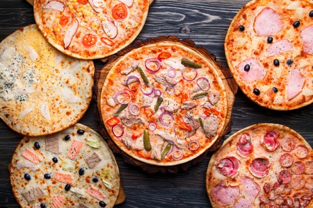 Six different pizza set for menu on wooden table. Italian food.の写真素材