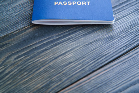 Passport on wooden table, copy space. Travel, changing citizensh