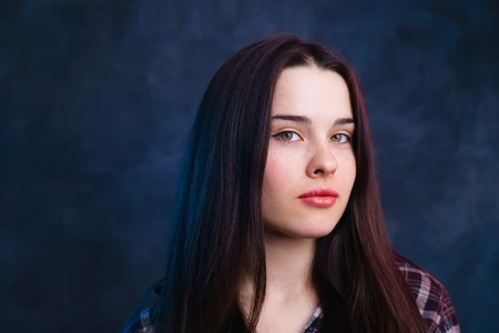 Young beautiful smiling girl with healthy skin and hair studio sの写真素材