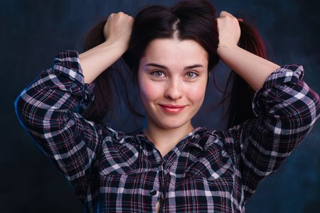 Young beautiful smiling woman with healthy skin and hair studioの写真素材
