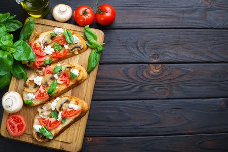 Delicious Italian antipasti chopped tomatoes, champignons, ricotの写真素材