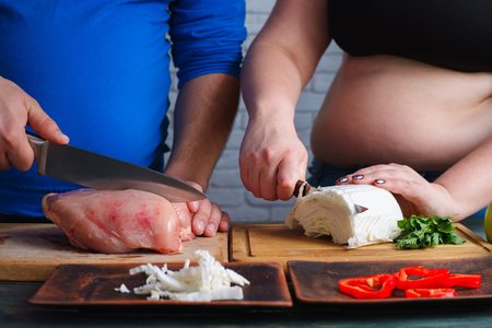 Overweight couple cooking diet food. Fat man and woman preparingの写真素材