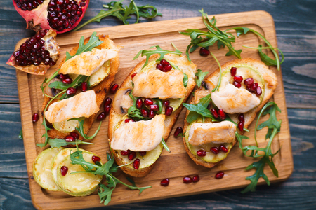 Tasty homemade Italian antipasti bruschetta with grilled chickenの写真素材