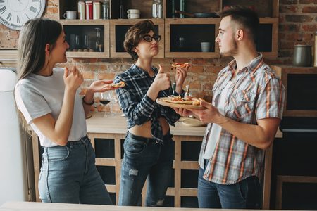 Friends thanking young man for delicious homemade self-preparedの写真素材
