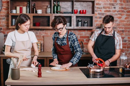 Cooking class. People preparing meals togetherの写真素材