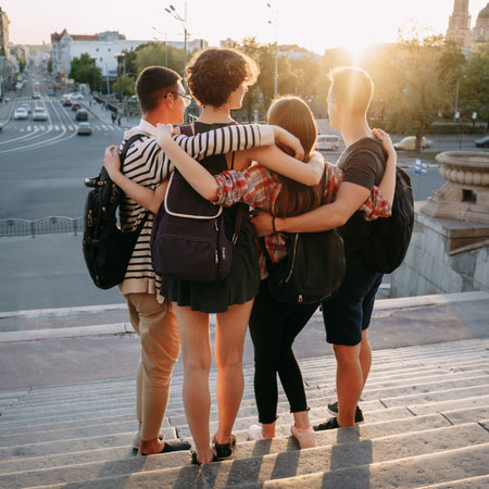 Happy young people hugging looking at city view