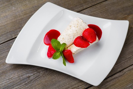 Ice cream with strawberry syrup, close up.の写真素材
