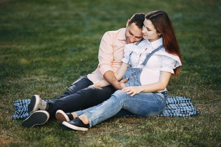 Pregnant couple enjoy time together at parkの写真素材