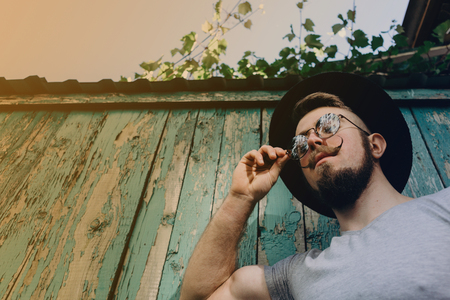 Hipster in sunglasses with fashionable mustachesの写真素材
