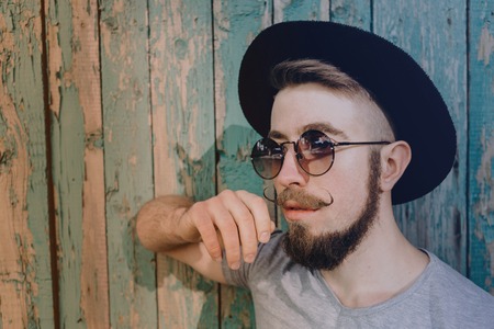 stylish hipster man in hat and sunglassesの写真素材