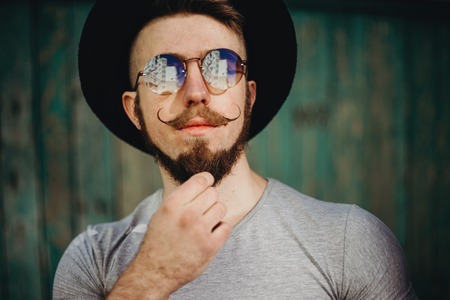 Hipster in sunglasses with fashionable mustachesの写真素材