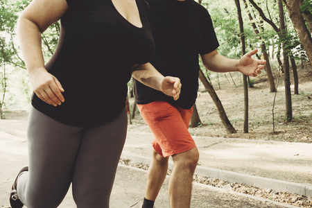 Overweight couple losing weight running togetherの写真素材