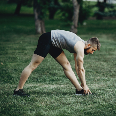 Runner doing stretching exercise before workoutの写真素材
