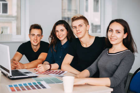 team of designers sitting together at studioの写真素材