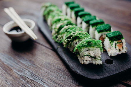 sushi rolls with chopsticks and sauce bowlの写真素材