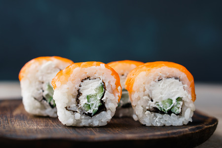 Japanese sushi on wooden plate, food backgroundの写真素材