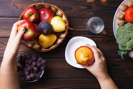 Woman choosing between junk food and fruits