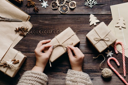 Female hands wrapping and decorating presentsの写真素材
