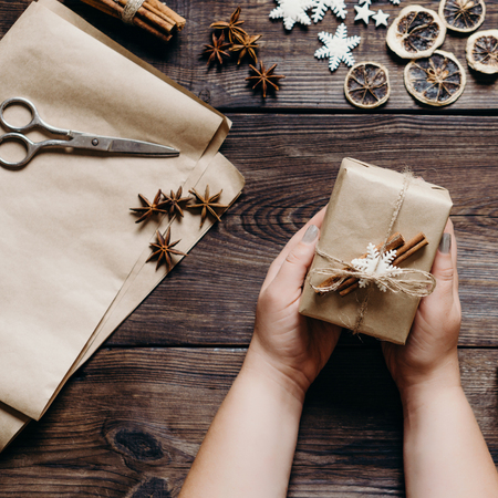 Female hands wrapping and decorating presentsの写真素材